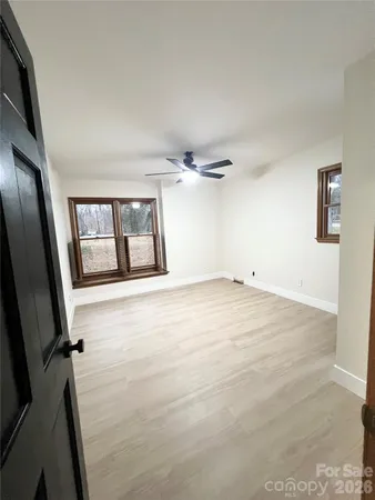 a view of an empty room with windows