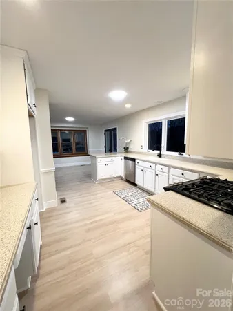 a large white kitchen with stainless steel appliances