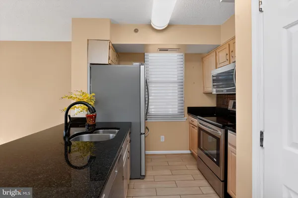 a kitchen with stainless steel appliances granite countertop a stove and a sink