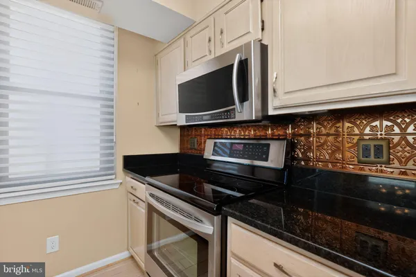 a kitchen with a stove and a microwave