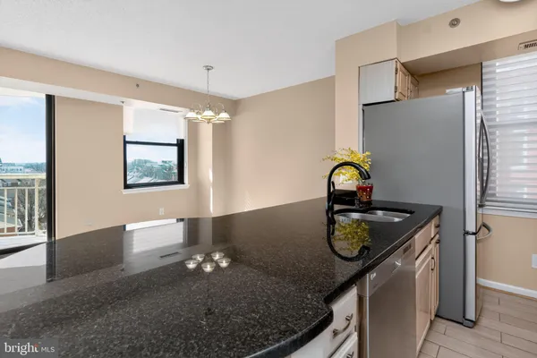 a kitchen with a sink appliances and cabinets
