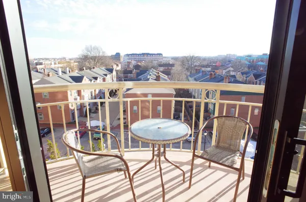 a view of a city from a dining room with furniture window and wooden floor