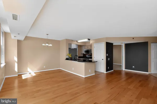 a view of a kitchen with a sink and a refrigerator