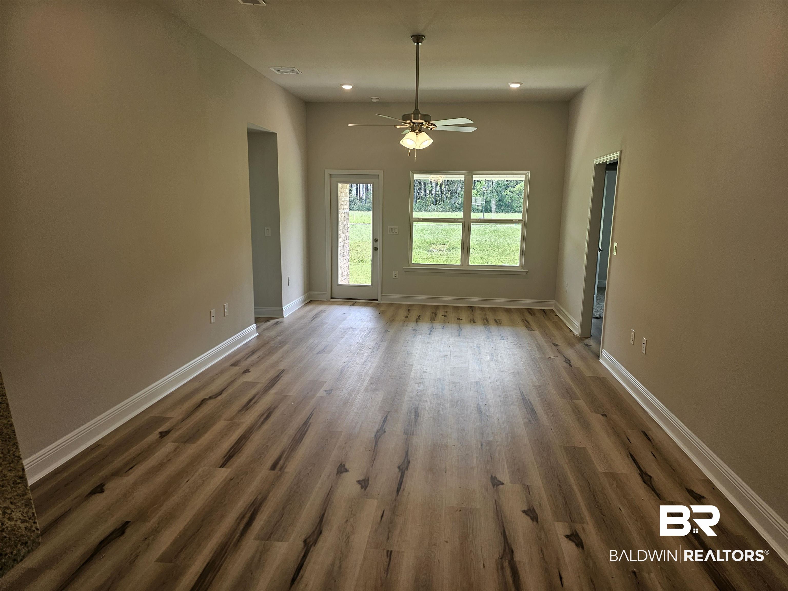 650 Revere Street Foley, AL 36535 - Photo 32 of 34 Empty room featuring ceiling fan and dark wood-type flooring