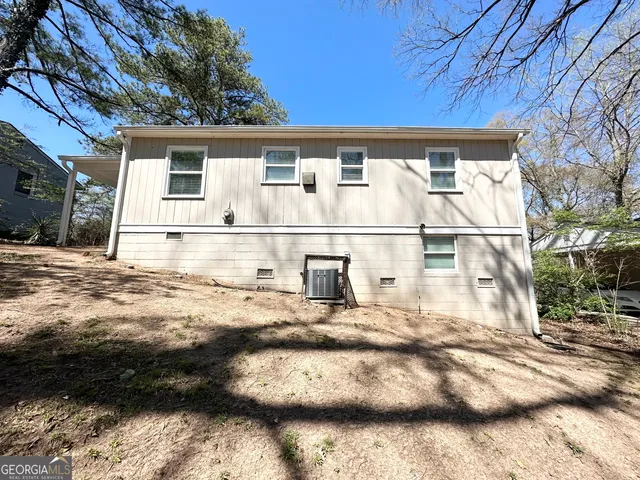 a view of a white house with a yard