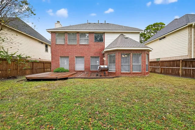 a view of a house with backyard and porch