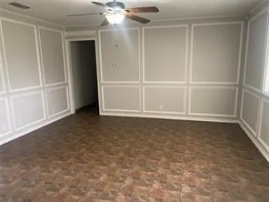 an empty room with a empty space and chandelier fan
