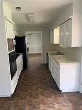 a kitchen with stainless steel appliances granite countertop a sink and a stove