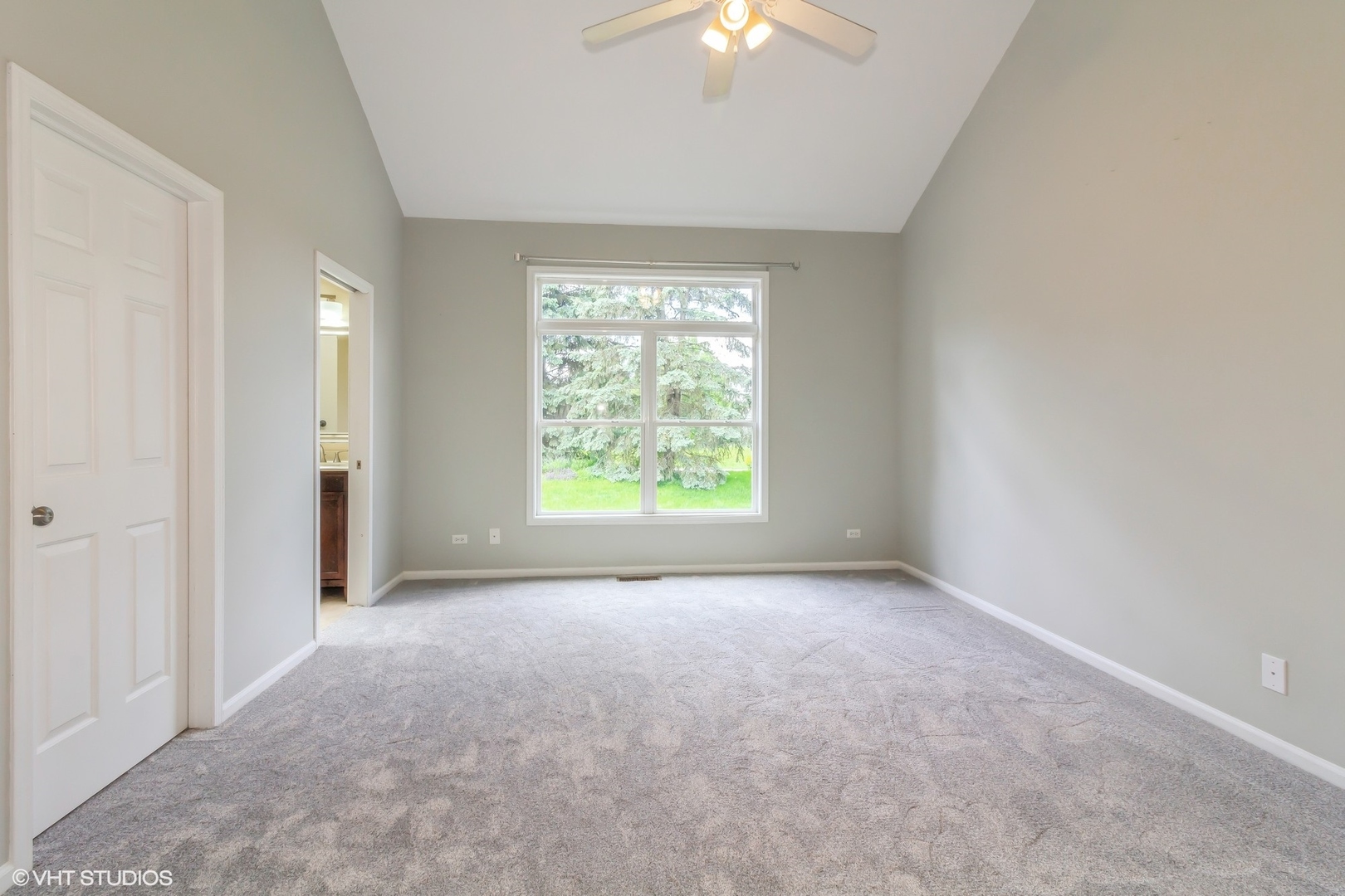 580 Chestnut Drive Oswego, IL 60543 - Photo 13 of 20 an empty room with windows and chandelier fan