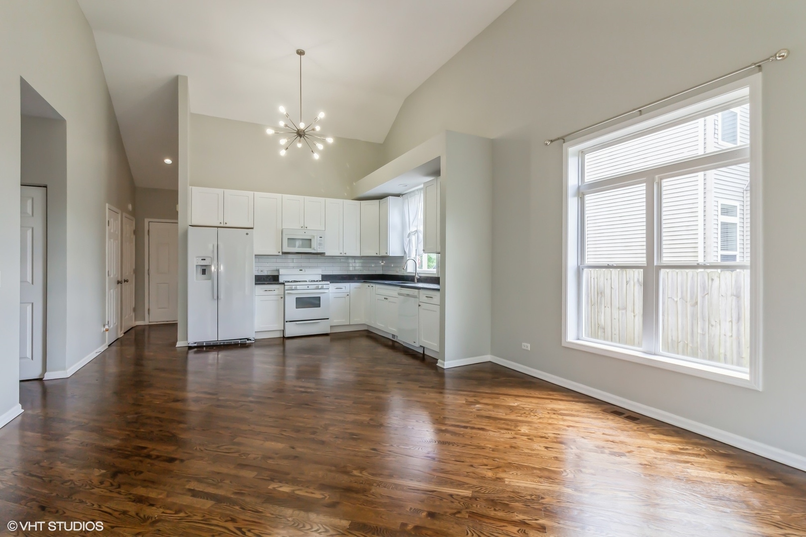 580 Chestnut Drive Oswego, IL 60543 - Photo 5 of 20 a view of an empty room with kitchen and window