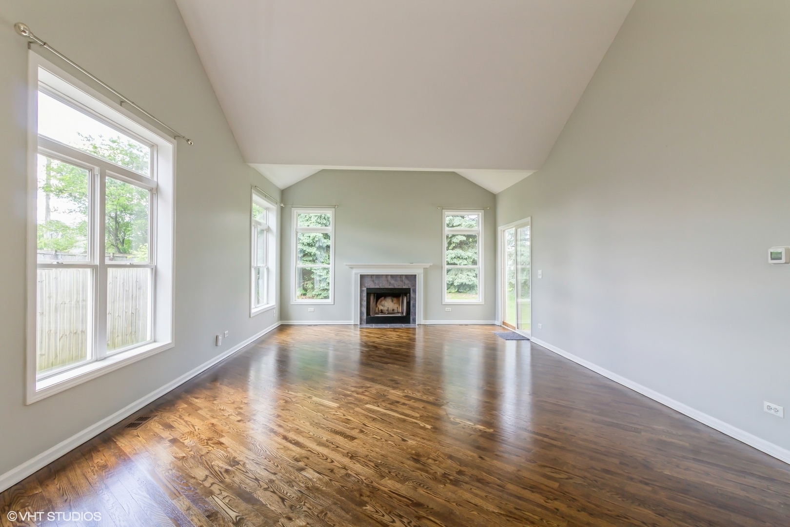 580 Chestnut Drive Oswego, IL 60543 - Photo 6 of 20 a view of an empty room with window and wooden floor