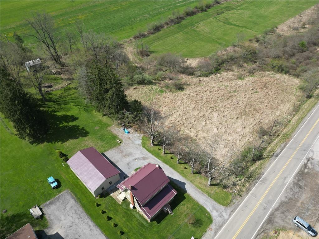 710 Herman Road Butler, PA 16002 - Photo 3 of 41 a view of a yard with lawn chairs large wooden fence