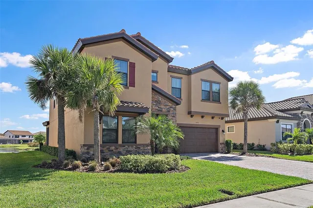 a front view of a house with a garden and plants