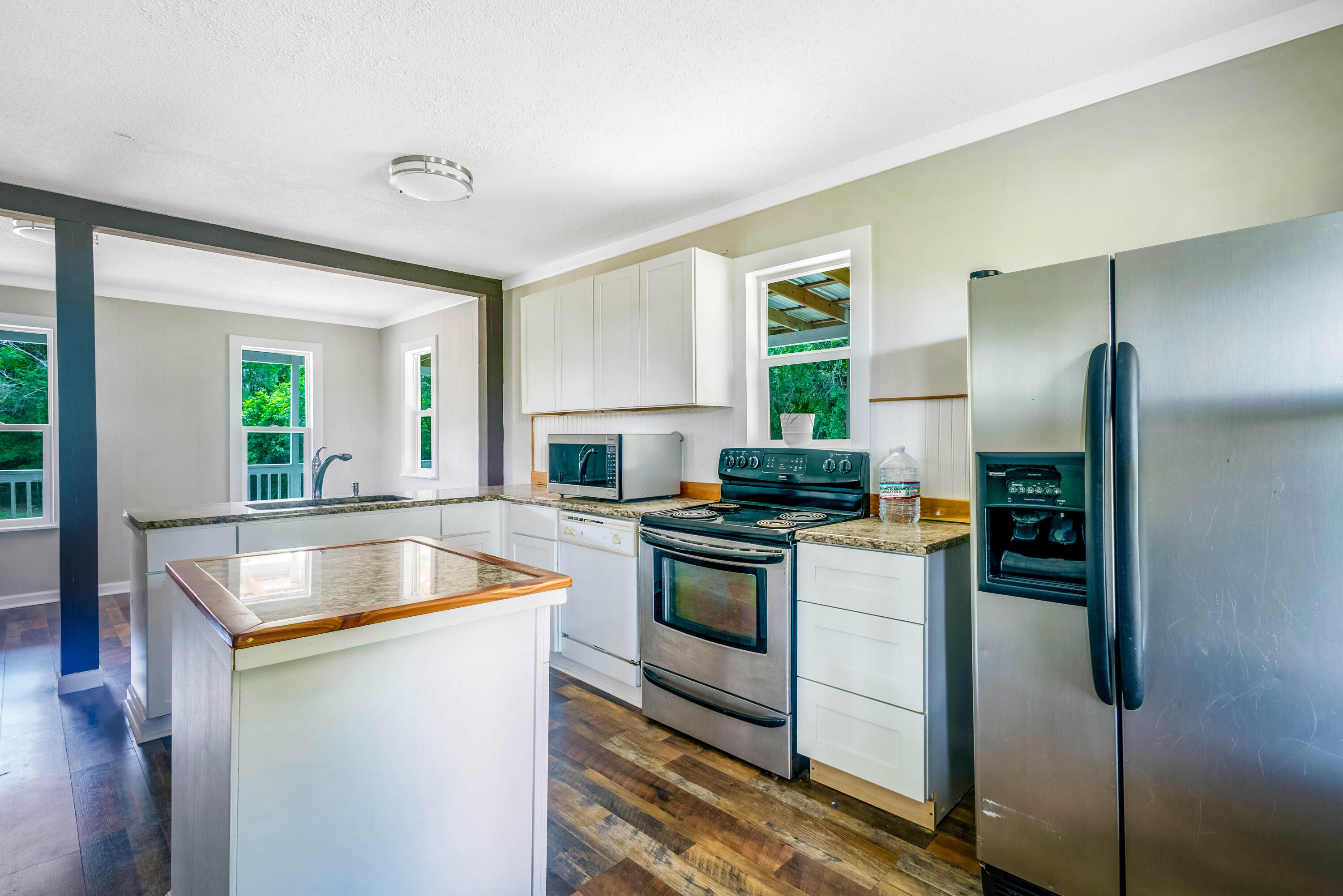 1650 Perkins Road Laurel Hill, FL 32567 - Photo 25 of 47 a kitchen with stainless steel appliances granite countertop a sink and a refrigerator