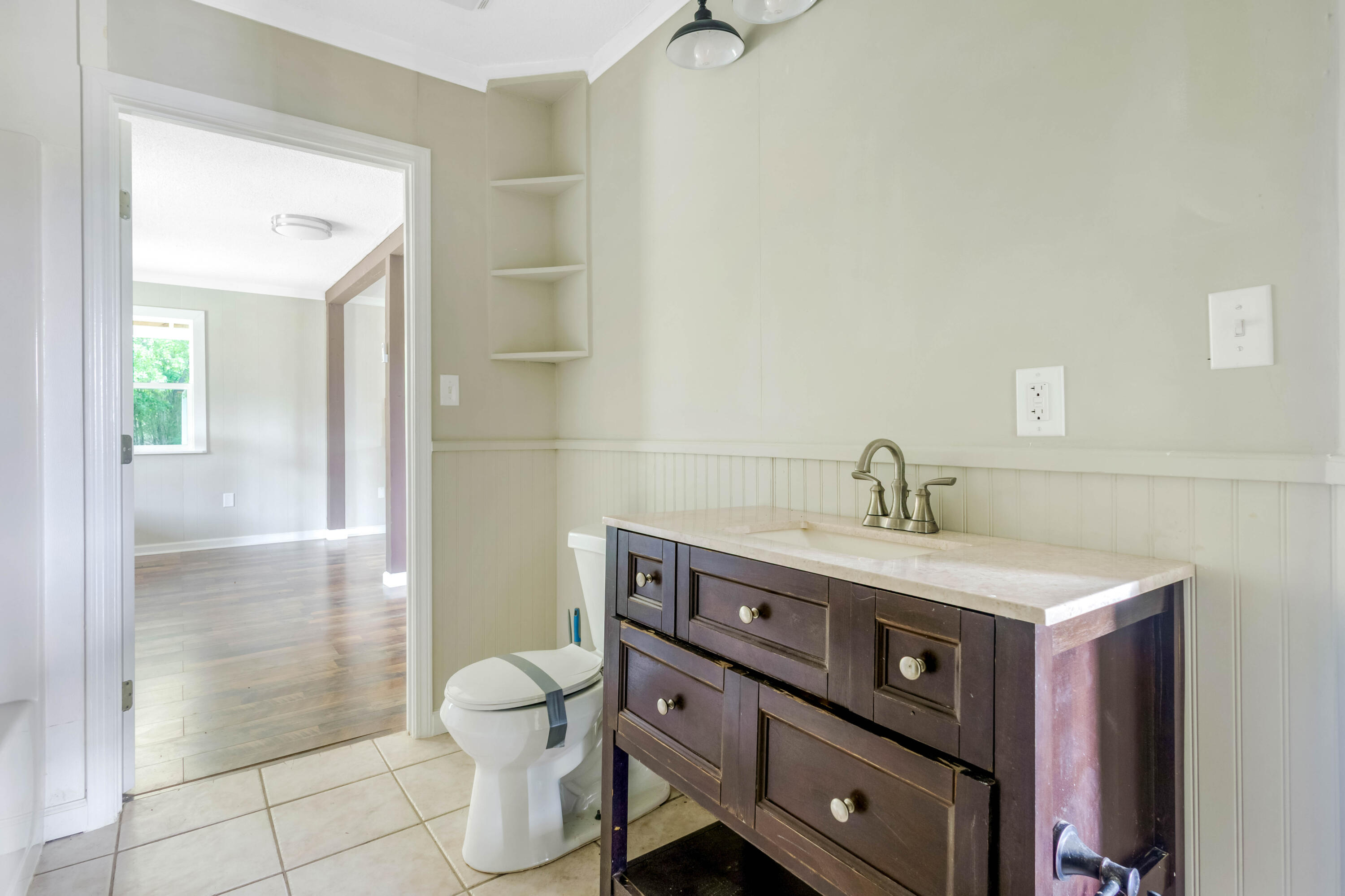 1650 Perkins Road Laurel Hill, FL 32567 - Photo 27 of 47 a bathroom with a sink a toilet and shower