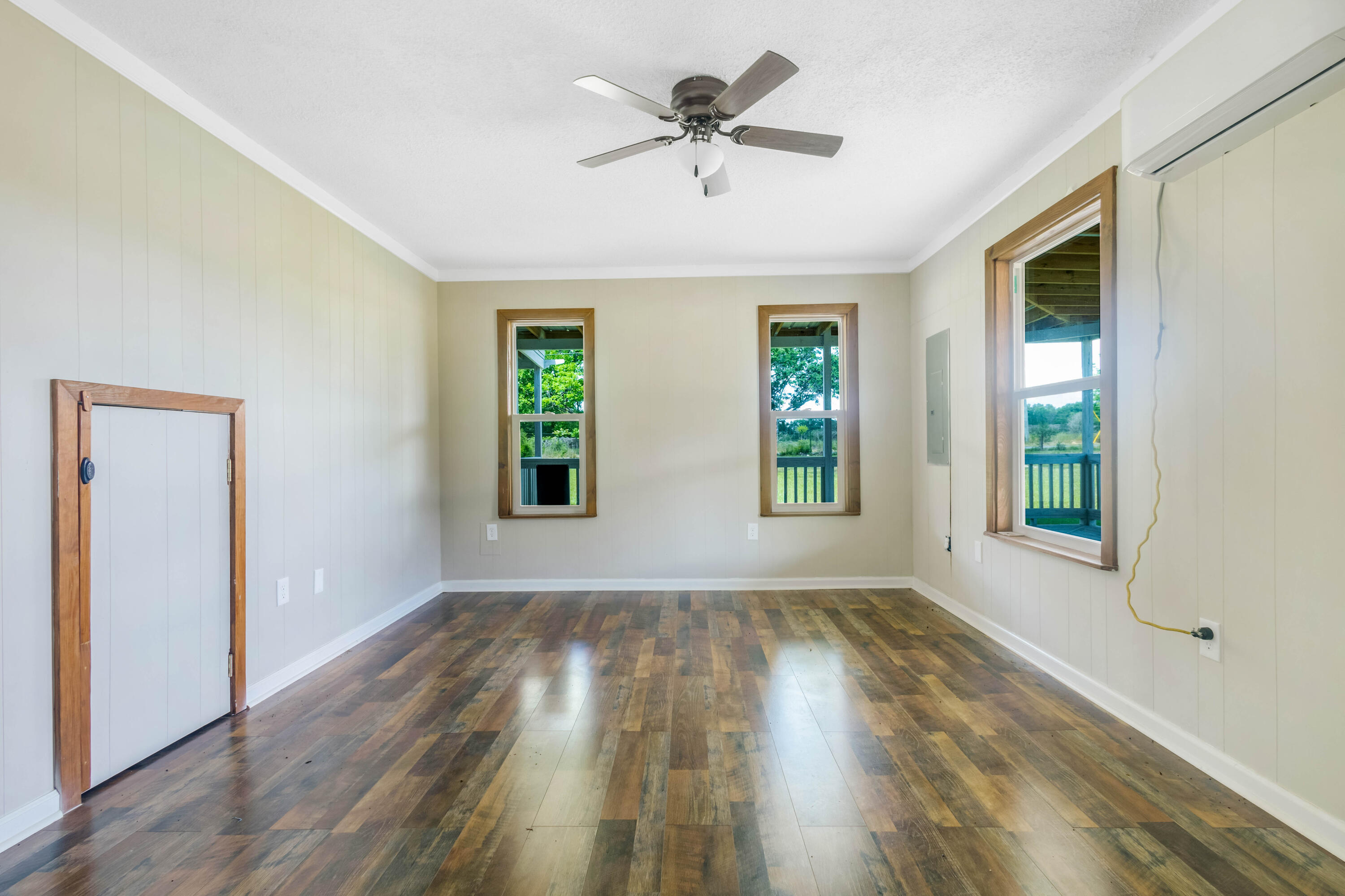 1650 Perkins Road Laurel Hill, FL 32567 - Photo 29 of 47 a view of an empty room with wooden floor and a window