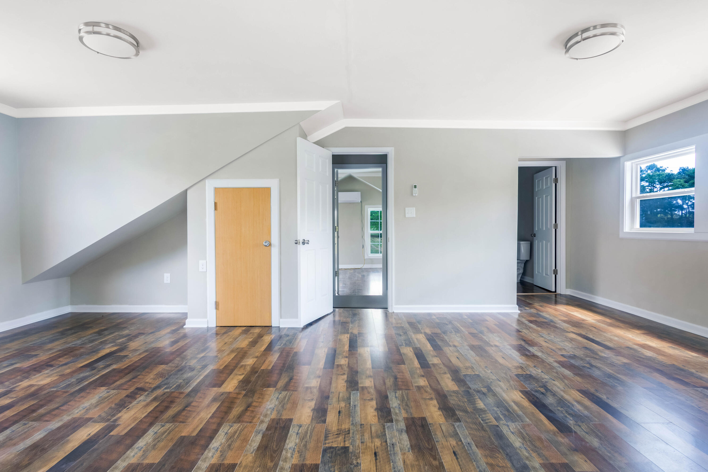 1650 Perkins Road Laurel Hill, FL 32567 - Photo 32 of 47 a view of an empty room with wooden floor and a window