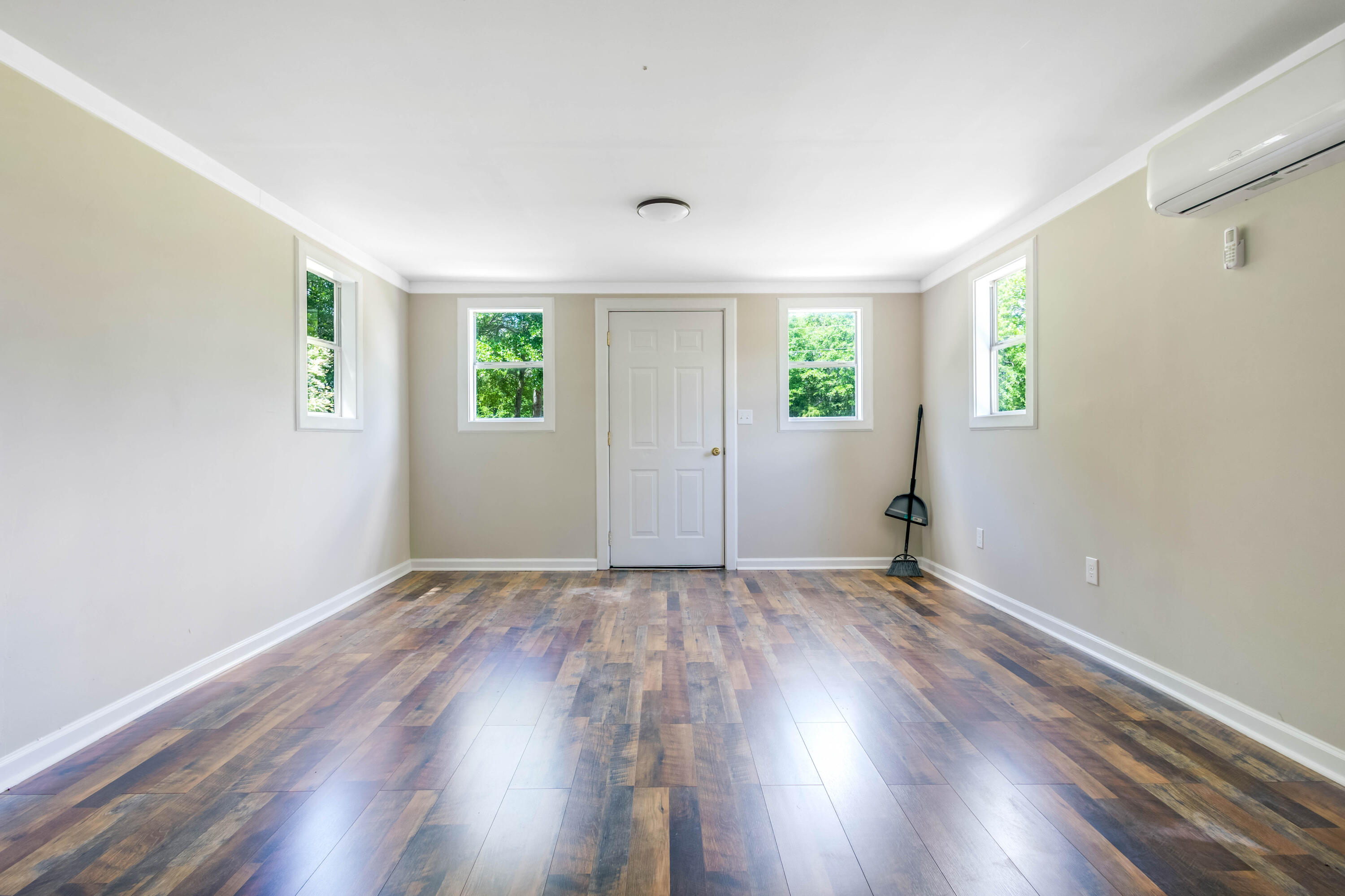 1650 Perkins Road Laurel Hill, FL 32567 - Photo 45 of 47 an empty room with wooden floor and windows