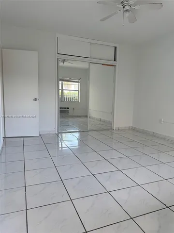 an aerial view of a city with lots of residential buildings ocean and mountain view in back