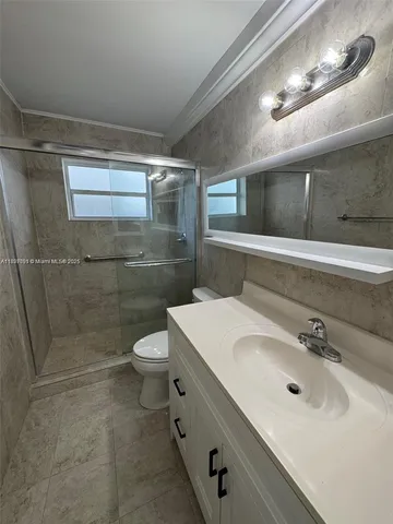 a spacious bathroom with a sink toilet and shower