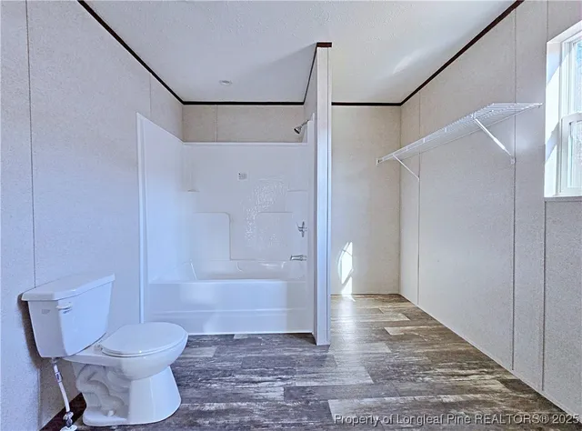a bathroom with a shower and a toilet