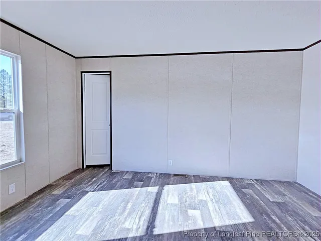 a view of a room with wooden floor