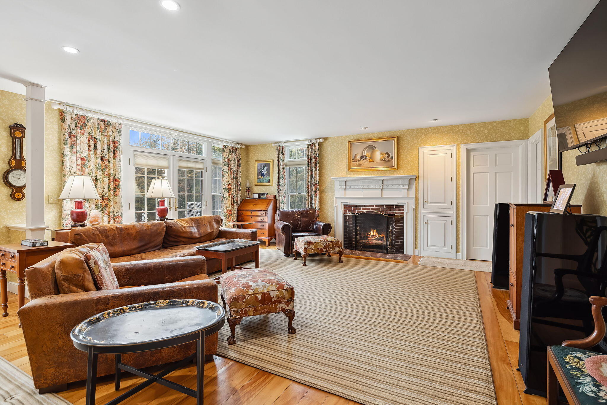 46 Freeman Lane Orleans, MA 02653 - Photo 14 of 74 a living room with furniture a fireplace and a flat screen tv
