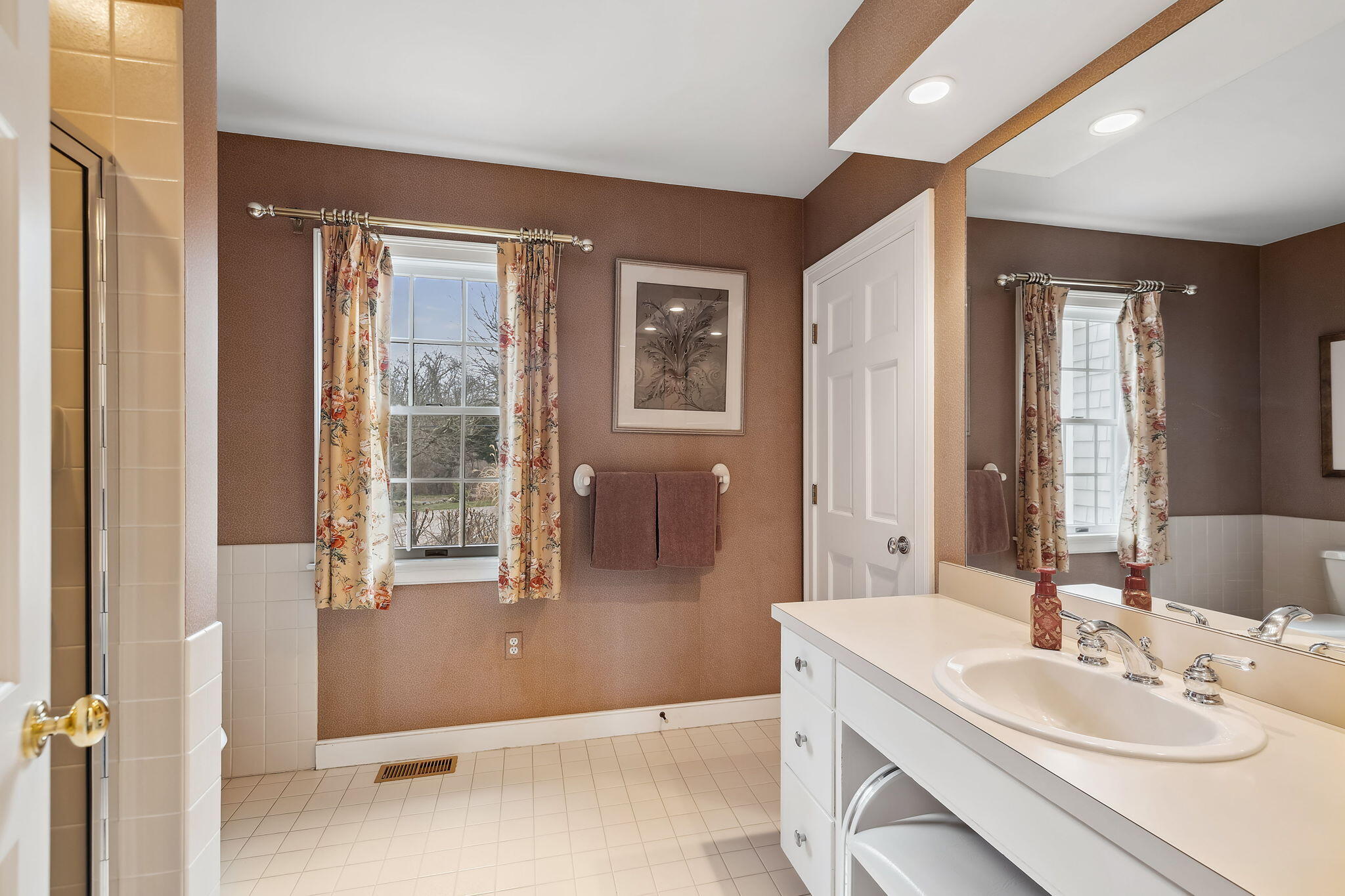 46 Freeman Lane Orleans, MA 02653 - Photo 29 of 74 a spacious bathroom with a granite countertop sink and a mirror