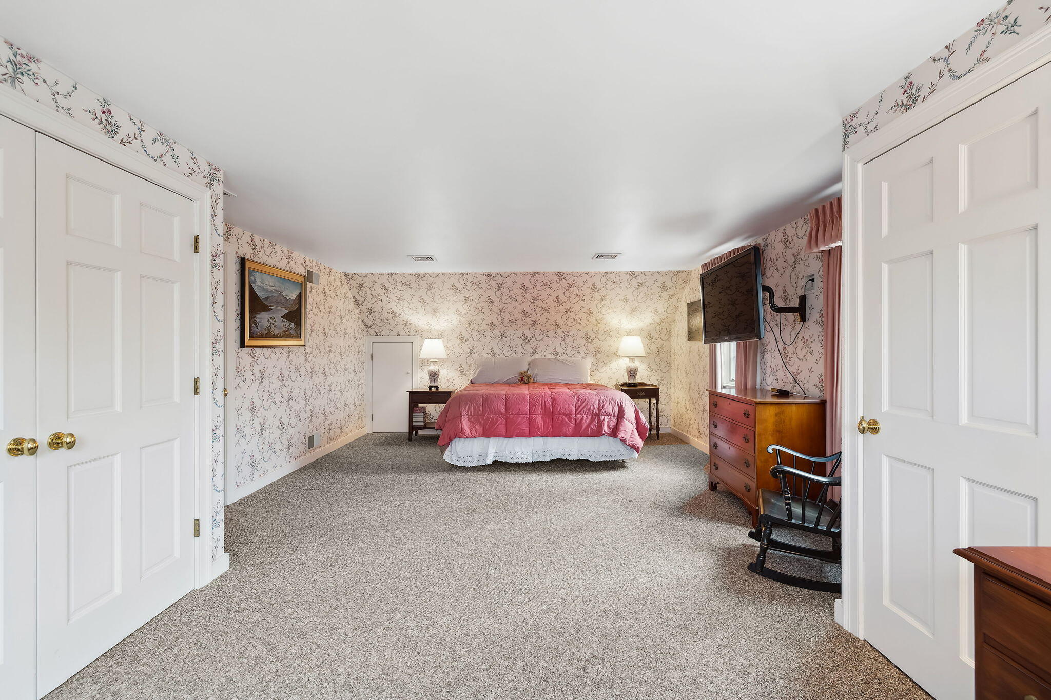 46 Freeman Lane Orleans, MA 02653 - Photo 30 of 74 a spacious bedroom with a bed and a couch