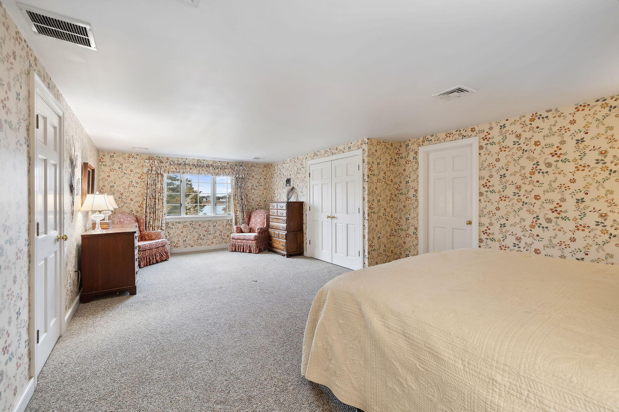 46 Freeman Lane Orleans, MA 02653 - Photo 36 of 74 a large bed sitting in a spacious bedroom next to a window and a larger closet