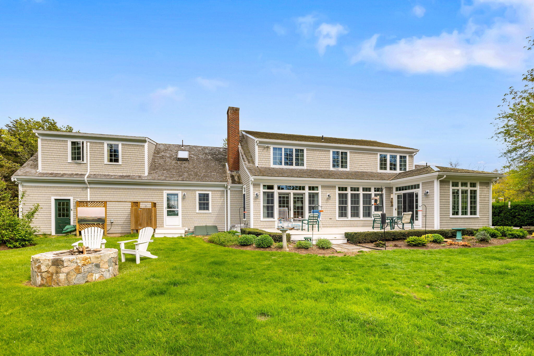 46 Freeman Lane Orleans, MA 02653 - Photo 51 of 74 a front view of a house with a garden and trees