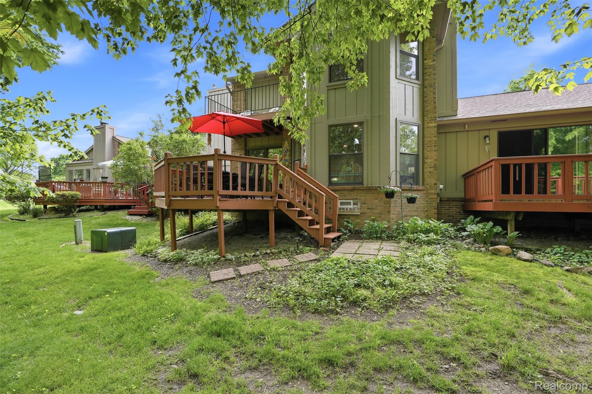 1687 Lodge Pole Lane Rochester, MI 48309 - Photo 30 of 53 Multi-level wooden deck with baluster railings