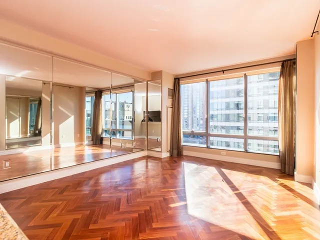 a view of an empty room with large windows
