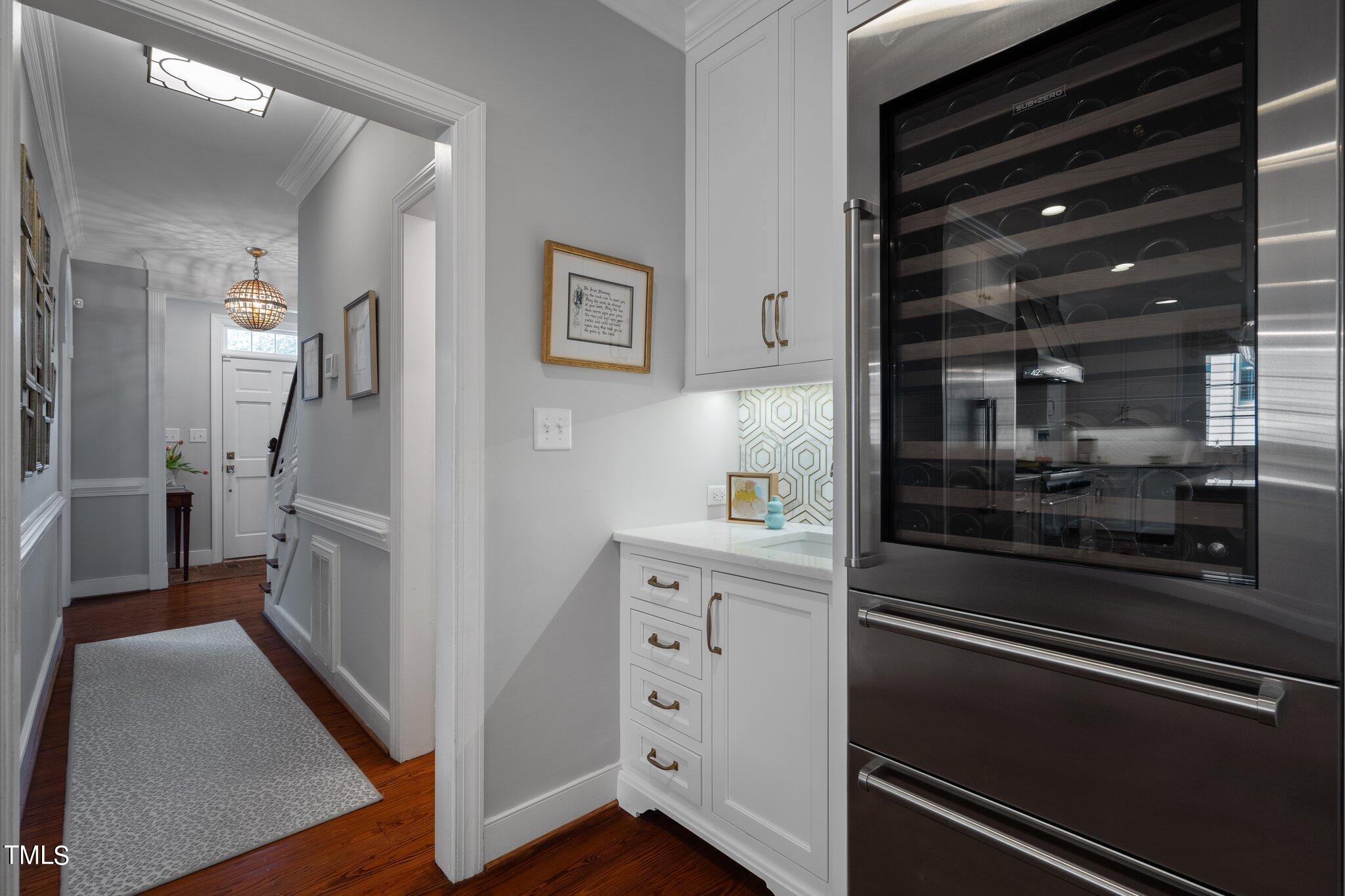 2335 Hales Road Raleigh, NC 27608 - Photo 22 of 65 a kitchen with white cabinets and stainless steel appliances