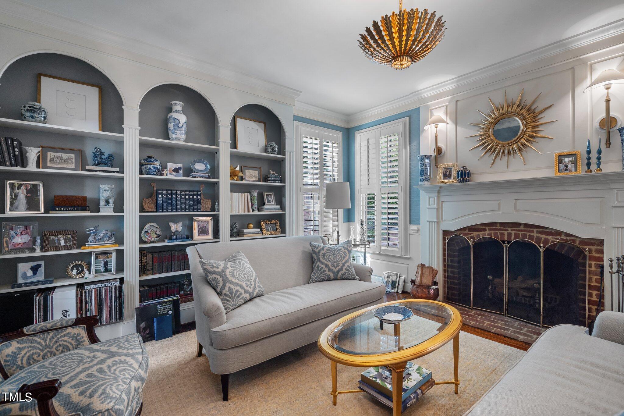 2335 Hales Road Raleigh, NC 27608 - Photo 24 of 65 a living room with furniture a rug and a fireplace