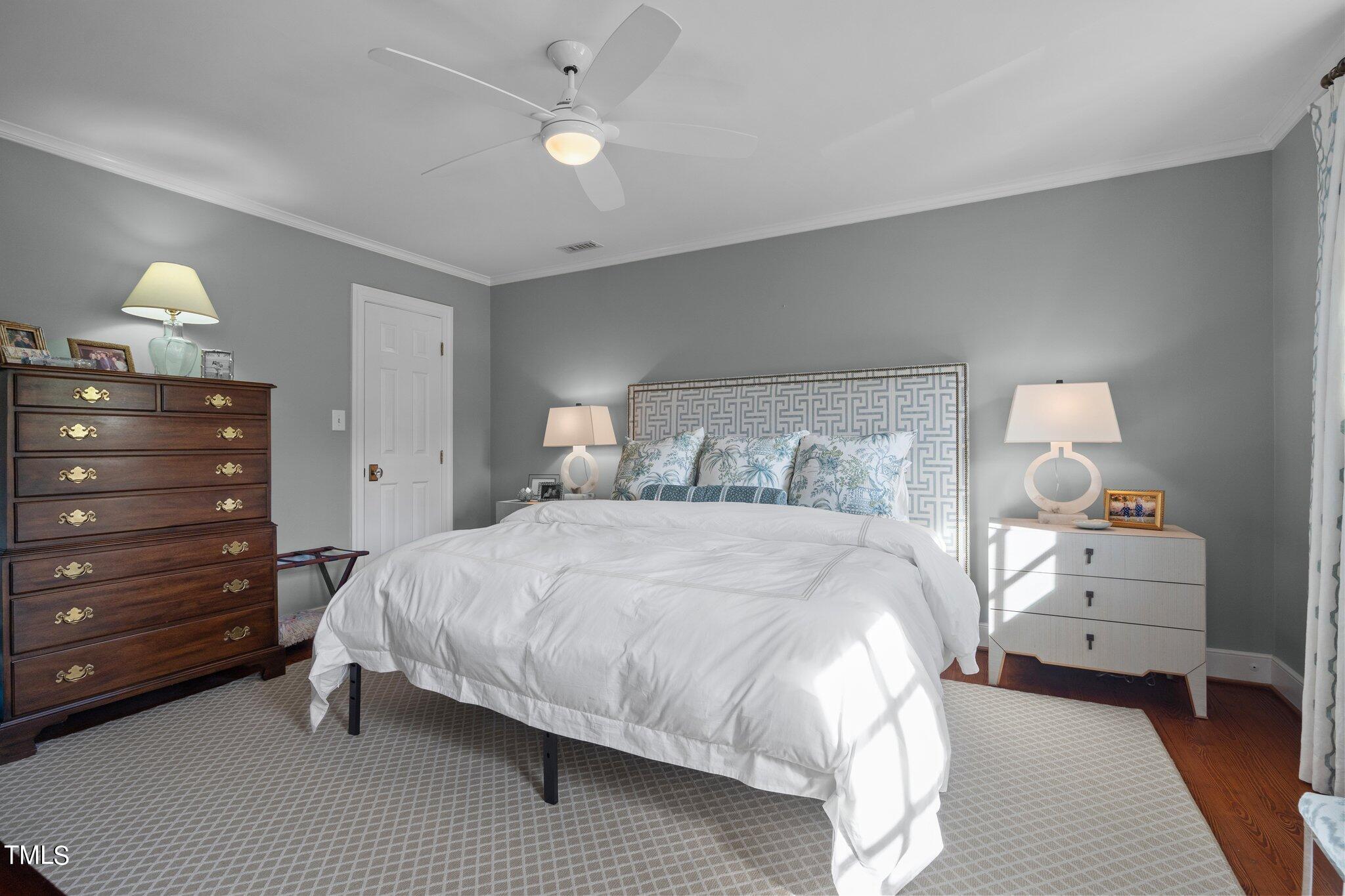 2335 Hales Road Raleigh, NC 27608 - Photo 47 of 65 a bedroom with a bed and wooden floor