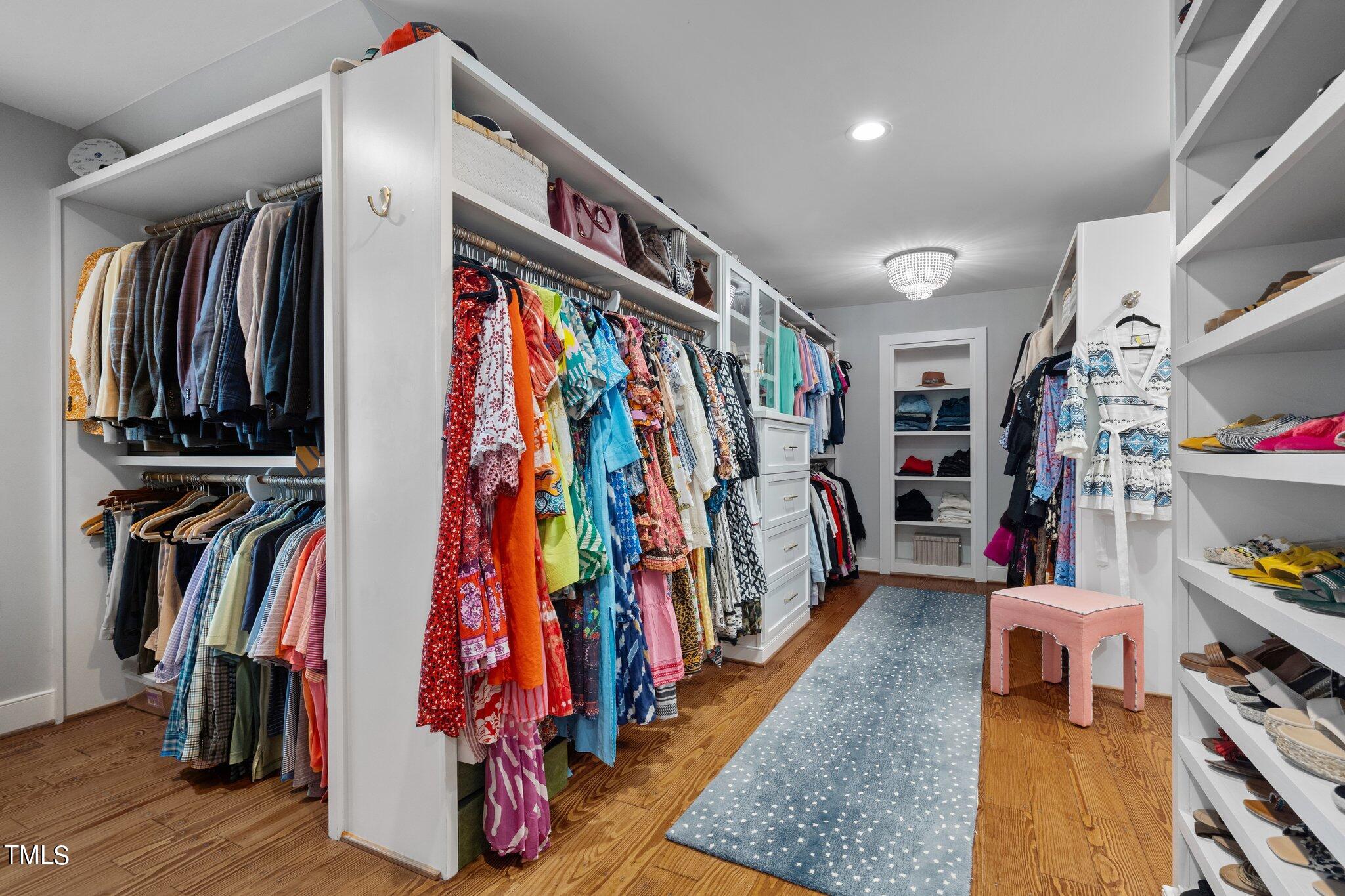 2335 Hales Road Raleigh, NC 27608 - Photo 54 of 65 a view of walk in closet with clothes and shoes