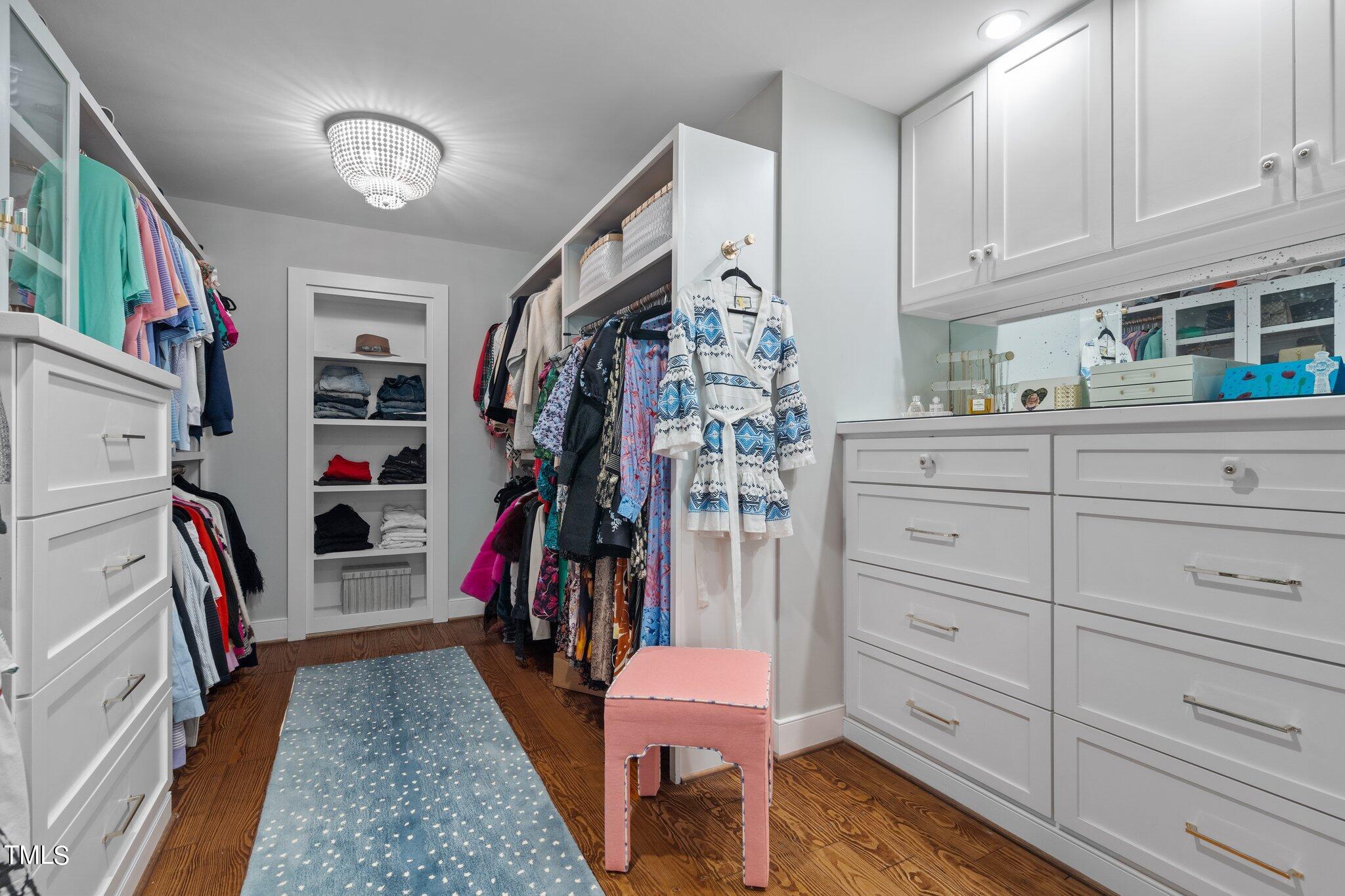 2335 Hales Road Raleigh, NC 27608 - Photo 55 of 65 a view of walk in closet with clothes and shoes
