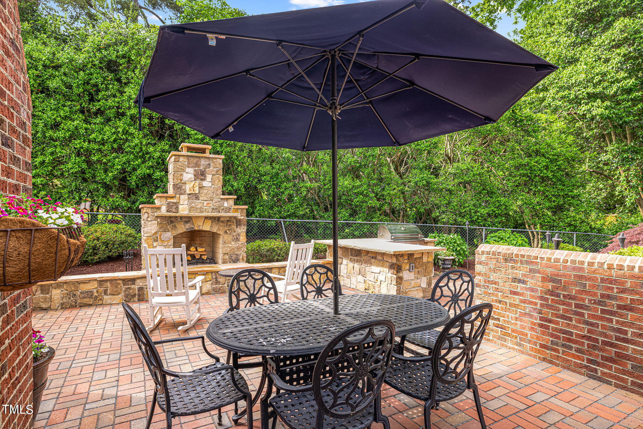 2335 Hales Road Raleigh, NC 27608 - Photo 8 of 65 a view of an outdoor sitting area with furniture and umbrella