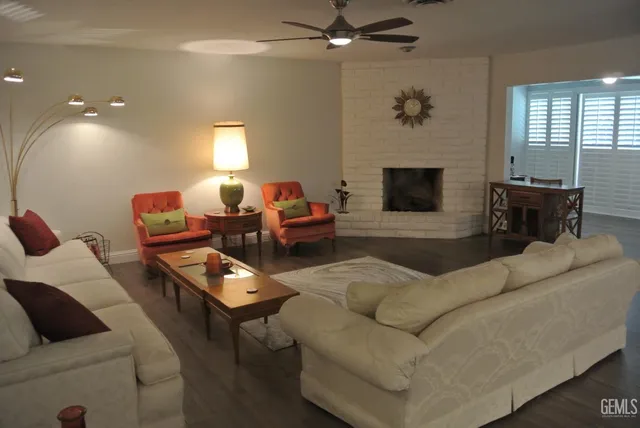 a living room with furniture a fireplace and a flat screen tv