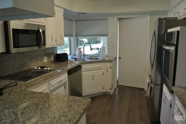a kitchen with a sink stove and refrigerator