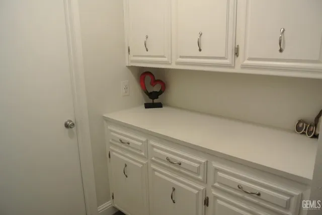 a kitchen with white cabinets and a sink