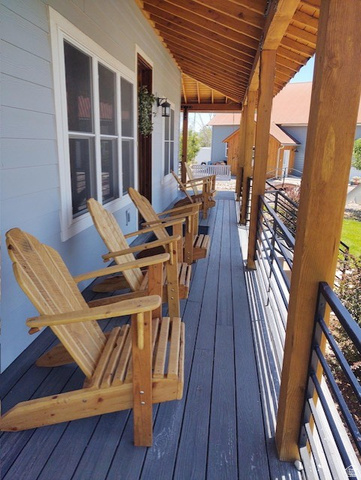 2170 Highway 357 Beaver, UT 84713 - Photo 9 of 56 Expansive covered porch featuring a wood-plank ceiling, exposed wood beams, composite decking, and horizontal metal railings