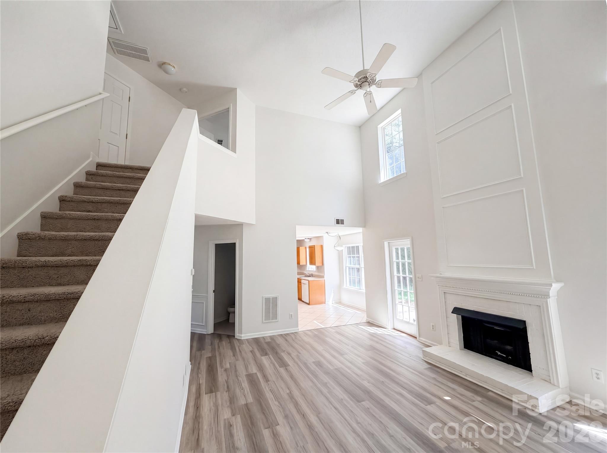 7423 Henderson Park Road Huntersville, NC 28078 - Photo 8 of 16 a view of a livingroom with wooden floor and fireplace