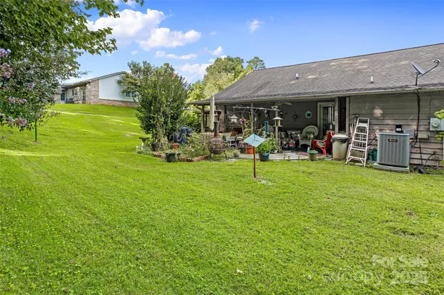 a view of a house with a backyard porch and sitting area