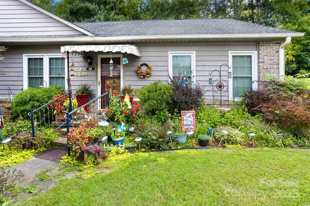 a front view of a house with a yard and outdoor seating