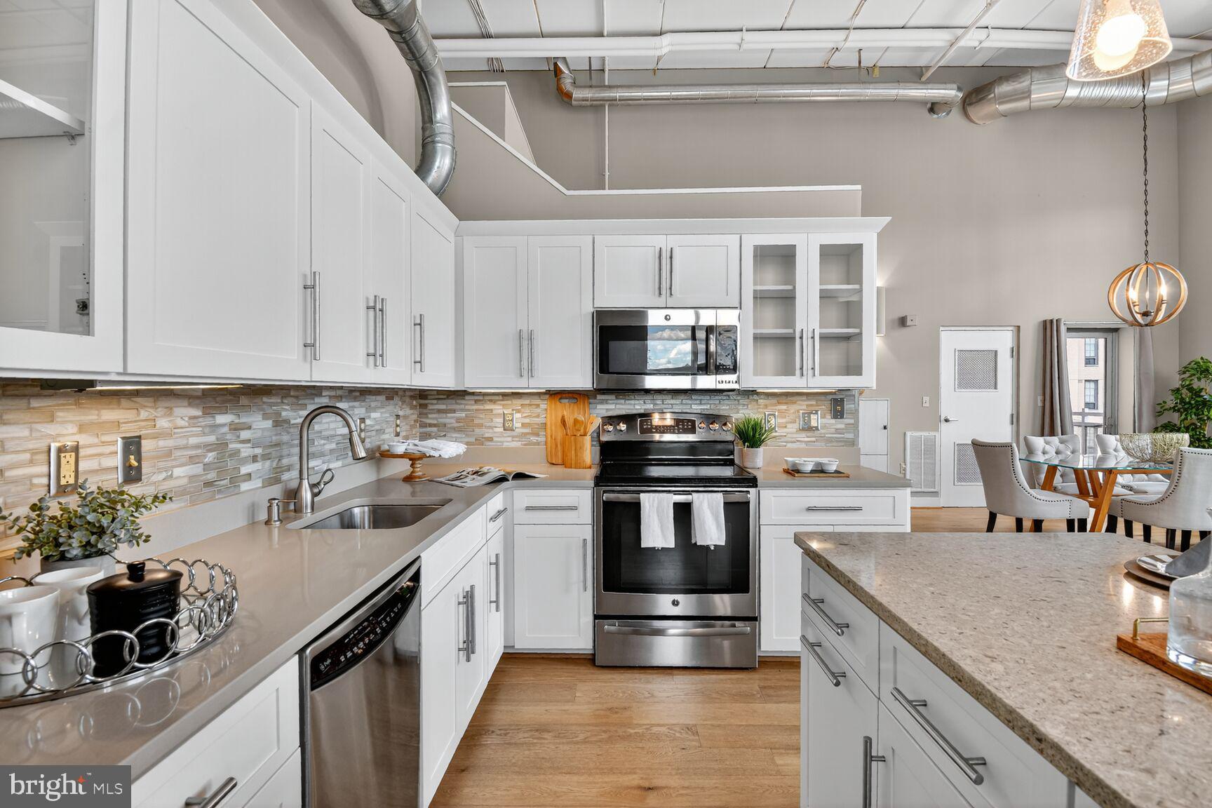 900 Bonifant Street, Unit D Silver Spring, MD 20910 - Photo 12 of 54 a kitchen with stainless steel appliances granite countertop a sink stove and refrigerator