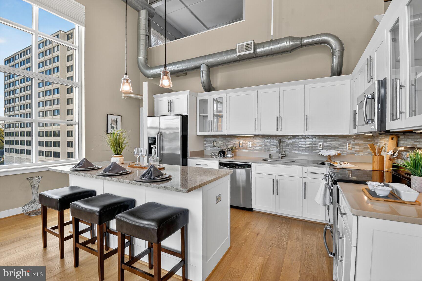 900 Bonifant Street, Unit D Silver Spring, MD 20910 - Photo 14 of 54 a kitchen with stainless steel appliances kitchen island granite countertop a sink and cabinets
