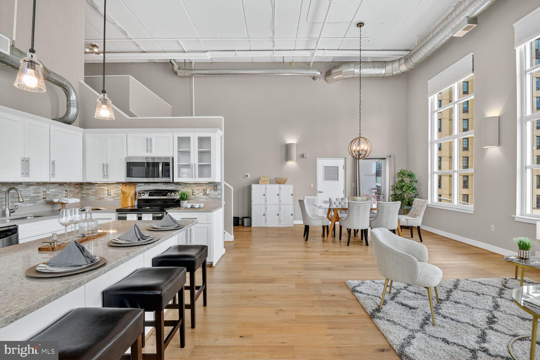 900 Bonifant Street, Unit D Silver Spring, MD 20910 - Photo 16 of 54 a open dining room with stainless steel appliances a table and chairs with kitchen view