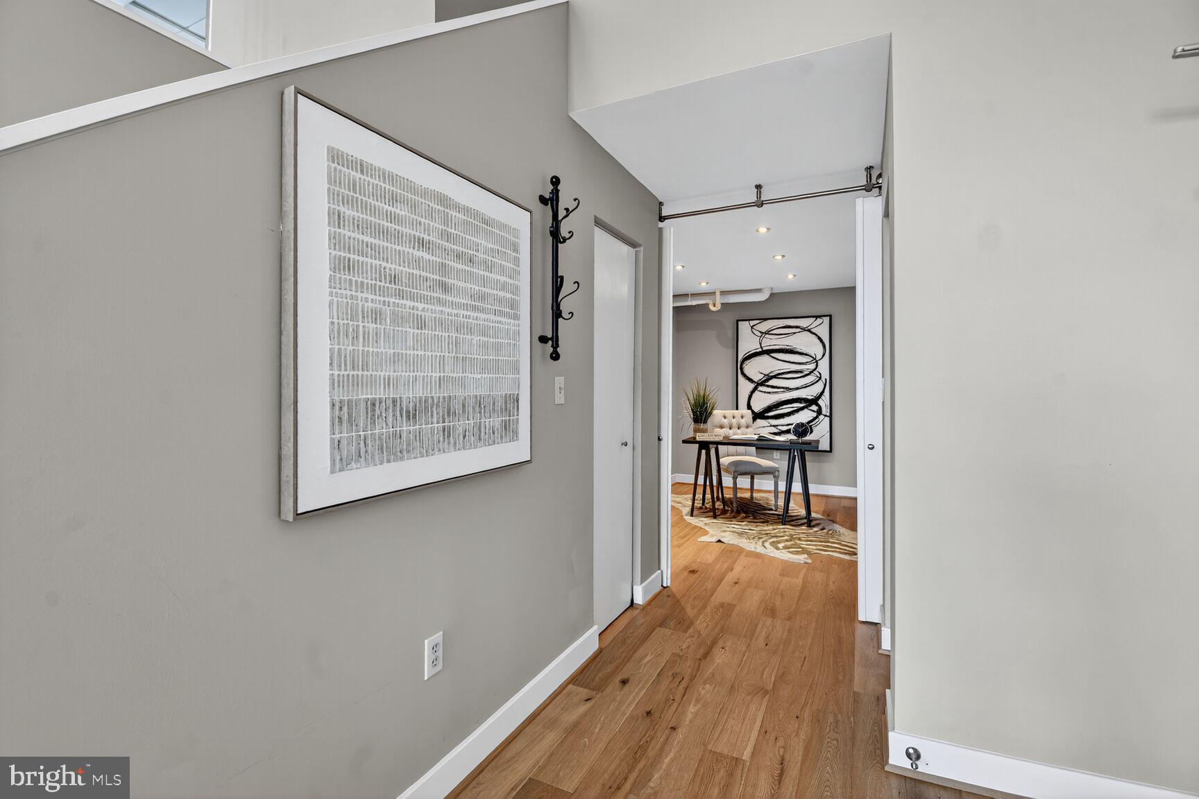 900 Bonifant Street, Unit D Silver Spring, MD 20910 - Photo 26 of 54 a hallway with wooden floor table and chairs